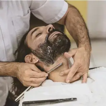 man lying back having a traditional wet shave